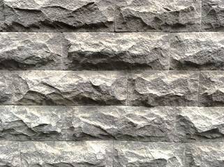A textured relief stone wall