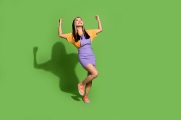 Full body photo of attractive young woman winning raise fists dressed stylish violet yellow clothes...