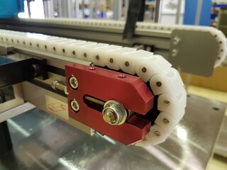 Chain tensioner of plastic chain conveyor has been installed to conveyor