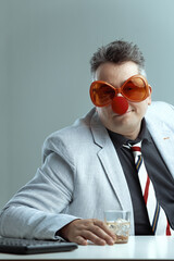 Silly man with whiskey, workplace drinking folly
