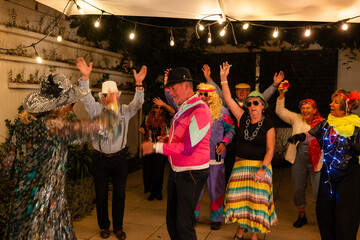 A diverse group of elderly individuals is seen having a joyous time at an outdoor costume party....