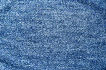 Naklejka premium Blue jeans fabric background texture. Background denim texture. Denim jean cloth in blue color. Close up view. Flat lay background.