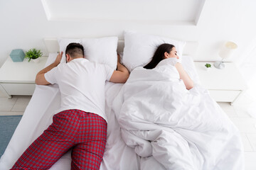 Photo of tired sleepy boyfriend girlfriend sleepwear lying comfortable bed indoors home bedroom