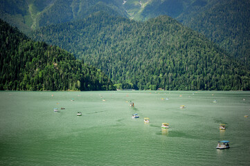 Catamarans on Lake Ritsa in Abkhazia. Walks on the water. Ecologically clean place in the mountains