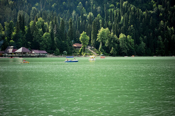 Catamarans on Lake Ritsa in Abkhazia. Walks on the water. Ecologically clean place in the mountains