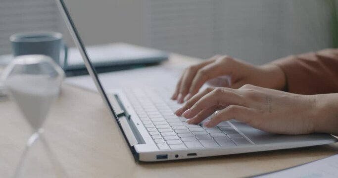 Close-up loop of female hands typing with keyboard while businesswoman working with computer in office. Job and modern technology concept.