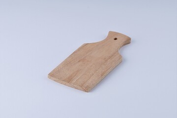 Wooden cutting board on white background with studio lighting
