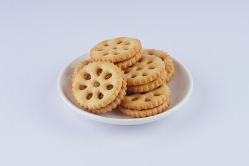 pineapple jam biscuits on a white plate over a white background with studio lighting