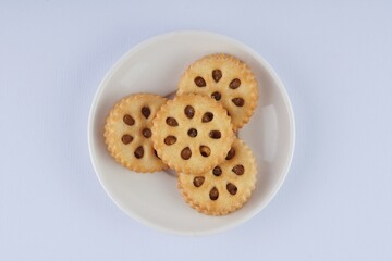 pineapple jam biscuits on a white plate over a white background with studio lighting