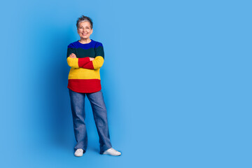Photo of cheerful glad lovely senior woman wear stylish clothes empty space isolated on blue color background