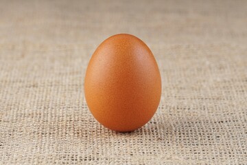 chicken eggs in a wooden bowl on a table with studio lighting