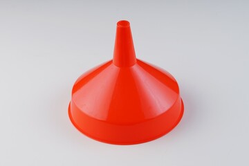 red plastic funnel on white background with studio lighting