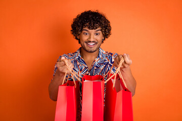 Photo portrait of handsome young man hold peek shopping bags dressed stylish colorful garment...