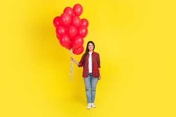 Full length photo of girlish lovely lady dressed checkered shirt holding balloons bunch isolated...