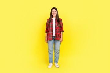 Full length photo of adorable pretty lady wear plaid shirt smiling empty space isolated yellow...