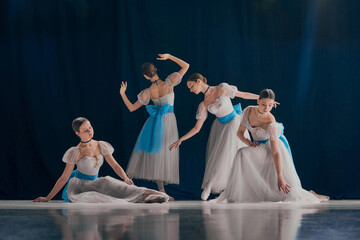 Quartet of dancers elegantly poised, each showcasing their unique ballet form in flowing white costumes adorned with blue bows. Concept of beauty, classic and modernity, contemporary art. Ad