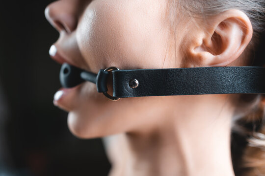 naked young sexy woman with gag ball in mouth, bdsm domination role playing games and fetish