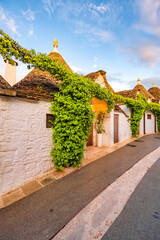 Trulli of Alberobello, Puglia, Italy. town of Alberobello with trulli houses among green plants and flowers
