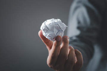 Woman holding crumpled paper ball. document in businessman hands. Office problems concept.