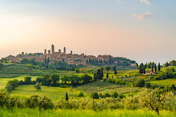 Medieval San Gimignano hill town with skyline of medieval towers, including the stone Torre Grossa....