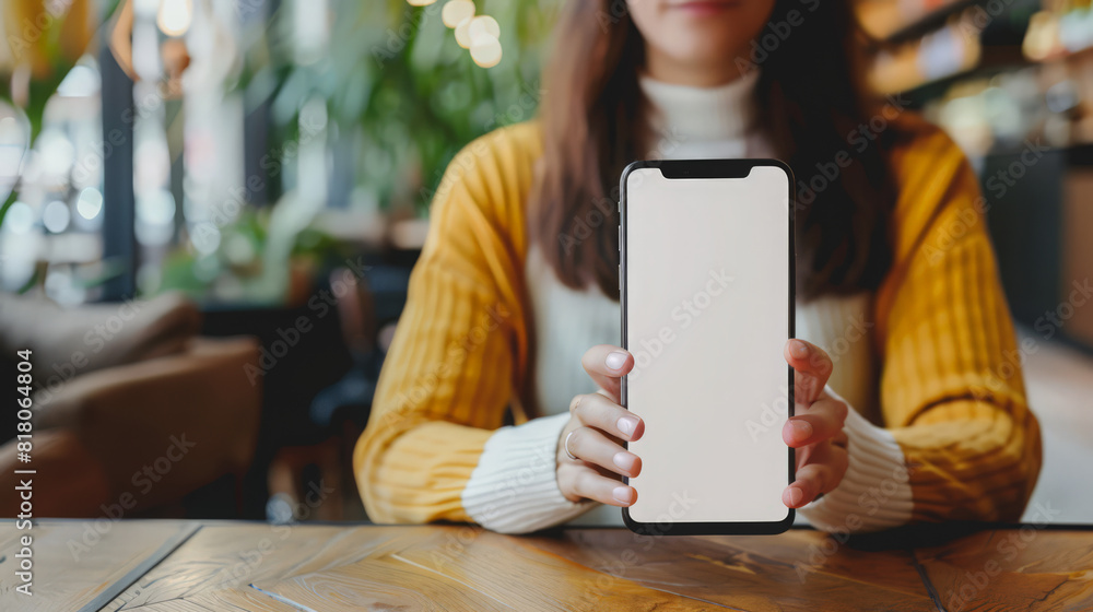 Poster mockup blank white screen mobile phone. woman sitting at table in cafe, using empty screen smartphon