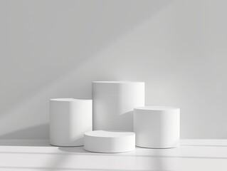 A minimalist image featuring three white cylinder pedestal podiums arranged against a light grey background. Ideal for product displays, design presentations, and contemporary art showcases.