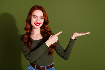 Photo of shiny attractive lady dressed shirt showing arm pointing finger empty space isolated green color background