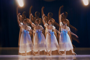 Mesmerizing shot of dancers in motion, their figures creating ghostly, shadow-like effect against...