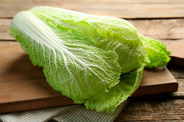 Fresh ripe Chinese cabbage on wooden table, closeup