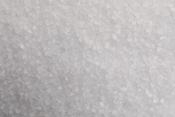 White natural salt as background, top view