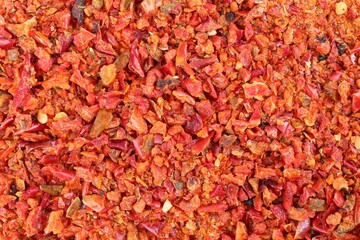 Aromatic spice. Red chili pepper flakes as background, top view