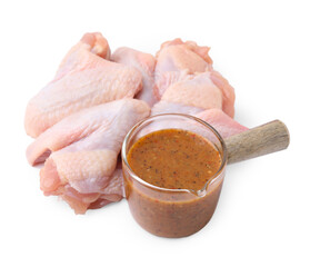 Fresh marinade and raw chicken wings isolated on white