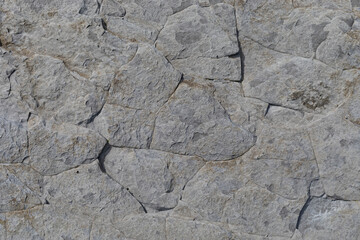 Stone texture worn by the wind and the sea of ​​the coast located on a wild beach.