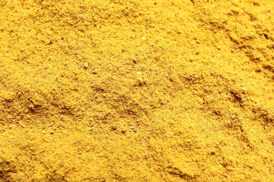 Dry curry powder as background, top view