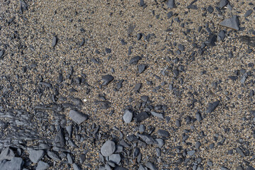 Mixed texture of small brown stones and black stone.