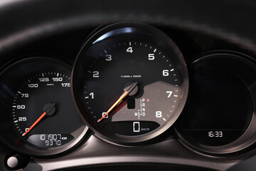 Speedometer and tachometer inside of modern car, closeup