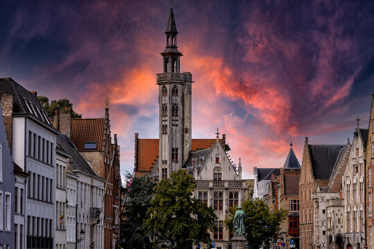 Bruges at sunset. The Chocolate City medieval old town in Flanders in Belgium Northern Europe. Tourist town with ancient gothic towers. architecture building, canals, cobbled alleys and flowers