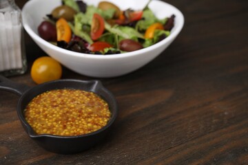 Tasty vinegar based sauce (Vinaigrette) on wooden table, closeup. Space for text