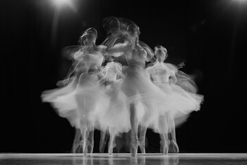 Group portrait of young, graceful ballerinas dancing on stage in black and white with motion blur effect. Movement. Concept of beauty, classic and modernity, contemporary art. Ad