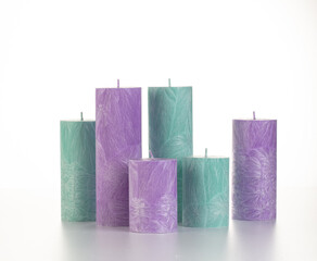 Collection of handcrafted pink and green palm wax candles of different sizes, ideal for adding warmth and comfort to everyday life, arranged against white backdrop
