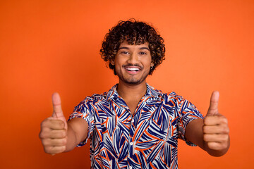Photo portrait of attractive young man thumb up dressed stylish colorful clothes isolated on orange...