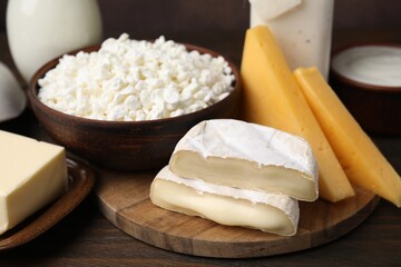 Different fresh dairy products on wooden table, closeup