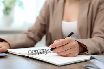 Secretary working at table in office, closeup
