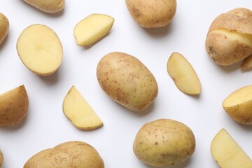 Fresh raw potatoes on white background, flat lay