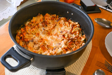 Baked pasta (casserole) with tomato sauce, onion and shrimp in big baking pan .