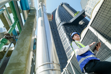 Industrial engineer adjusting pipeline valve with radio communication on construction site....