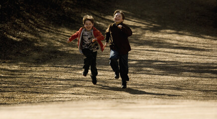 Fototapeta premium Boys Running Together