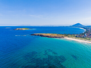 Aerial view of Bai Xep beach in Phu Yen province, Vietnam. Tropical coast from cliff above. Vietnam travel destination, golden sand beach waving sea rock boulders.