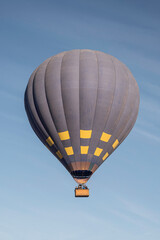 Naklejka premium A big, hot air balloon, floating in a blue summers sky