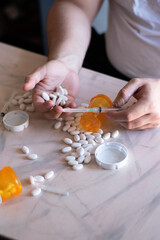Sadness and addicted person with many drugs and vacum front her on the table